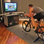 This custom indoor bike system, invented by Paul Krumrich, melds home-theater components witha a computerized resistance hub and bike-training software to allow a rider to become ensconced in a virtual experience.