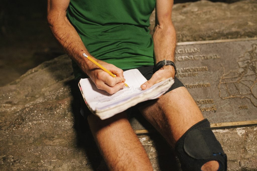 Karl Meltzer adds the last info to his logbook after breaking the record for running the length of the Appalachian Trail on 18 September, 2016.