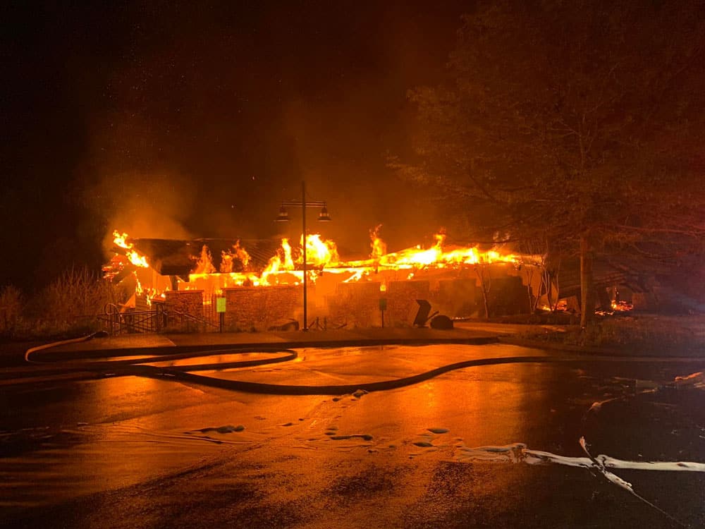 The Ocoee Whitewater Center building engulfed in flames at night