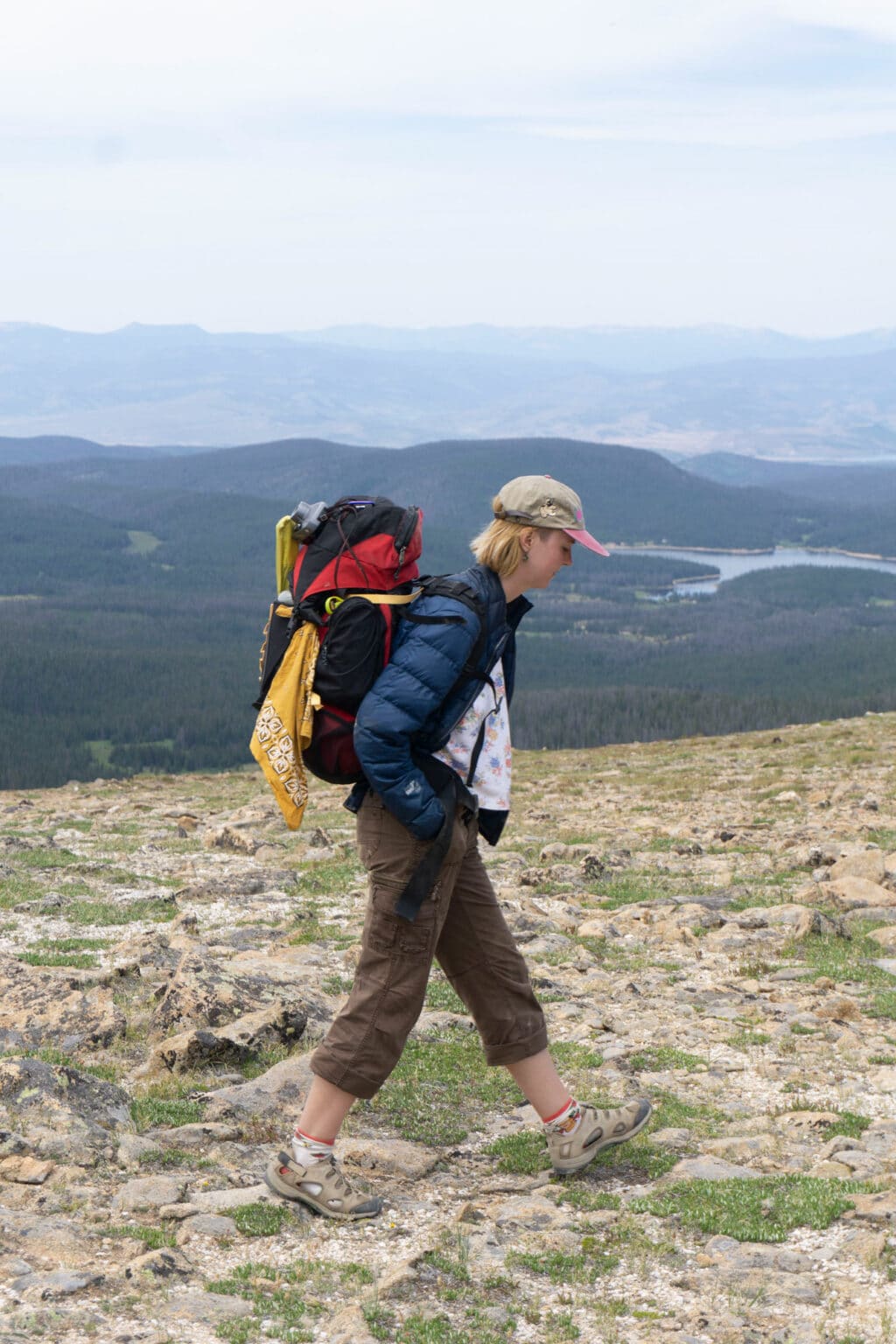 young woman hikes with backpacking back pack on